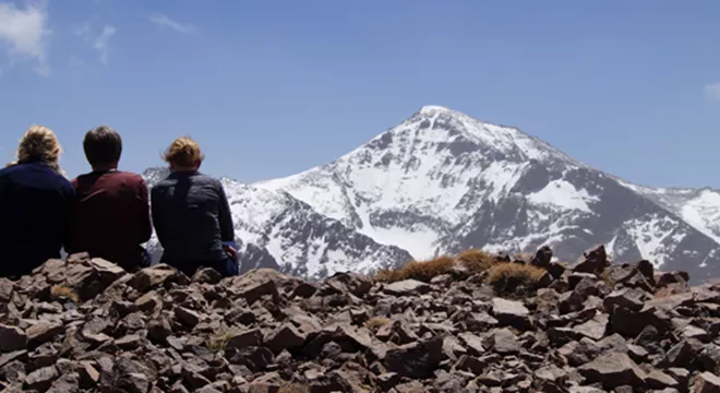 Three walkers looking at Mount Toubkal Atlas Mountains